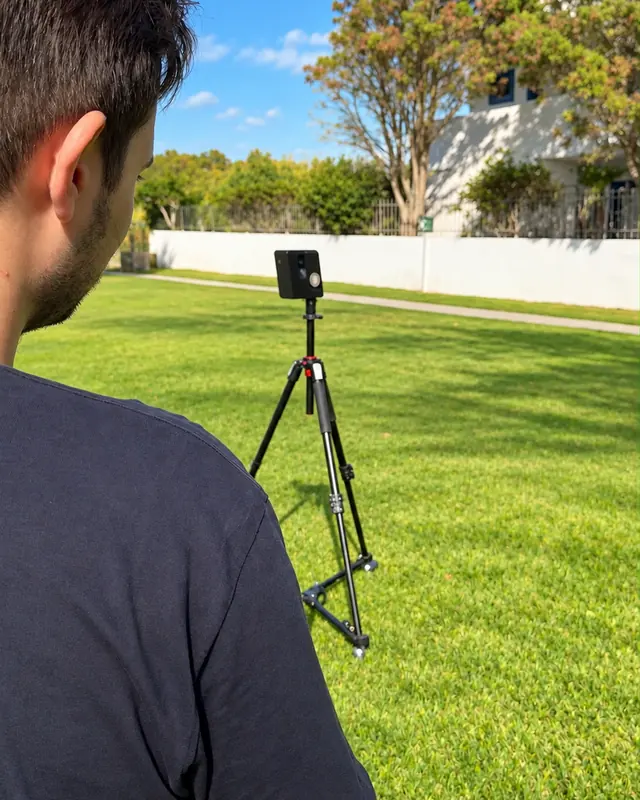 Vivestia team member setting up a 3D camera on a tripod during on-site scanning